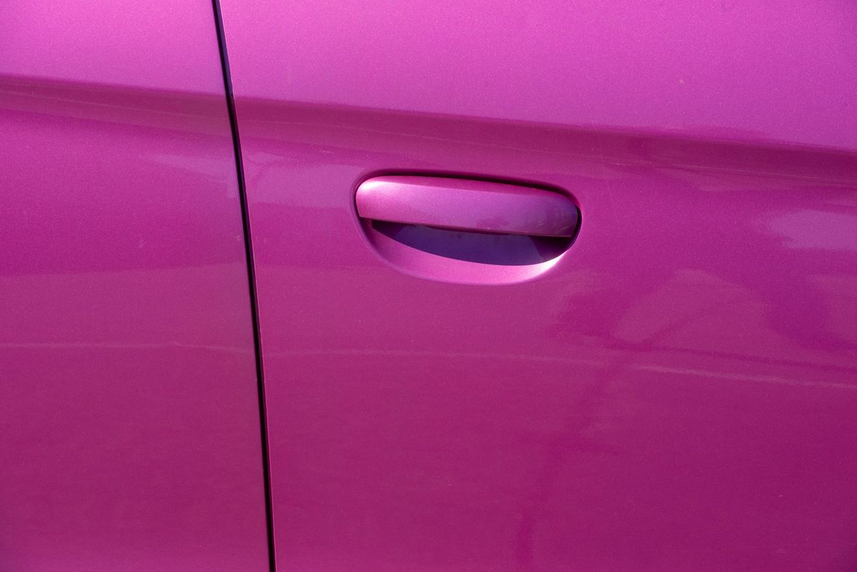 Professional applying ceramic coating to a vehicle in a clean Chandler area detailing bay
